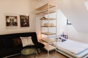 a bedroom with a bed and a book shelf at Street Food Possonium Apartments in Bratislava