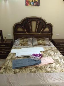 a bed with two pillows and a robe on it at Apartments Oriental Chalet RedSeaLine in Hurghada