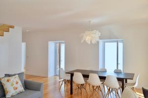 a dining room with a table and chairs at Fisherman's House - a boat ride from Lisbon in Trafaria