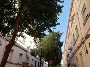 a street with two buildings and a street light at Acogedor in Zaragoza