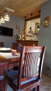 a dining room table and chairs with a kitchen in the background at Auszeithütte in Flattnitz