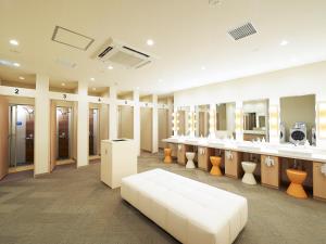 a large dressing room with a white couch in it at THE POCKET HOTEL Kyoto Shijo Karasuma in Kyoto