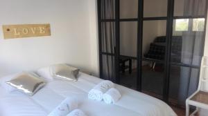 a bedroom with a white bed with towels on it at Golden Apartment City Center in Lisbon