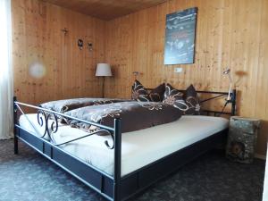 een bed in een kamer met een houten muur bij Rüf Stefanie in Au im Bregenzerwald