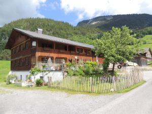 a wooden house with a fence in front of it at Rüf Stefanie in Au im Bregenzerwald