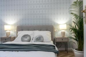a bedroom with a large bed with two night stands at Apartment Nearto Old Town Kraszewskiego street in Krakow