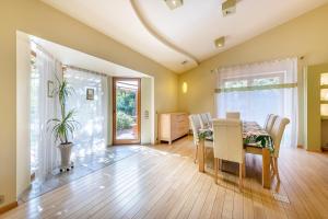 a dining room with a table and chairs at Villa EverGreen near the city center with private garden, hot tub, garage parking, patio in Vilnius