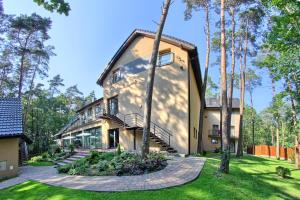 an exterior view of a house with trees at Hotel Zacisze in Turawa