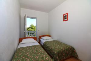 Postel nebo postele na pokoji v ubytování Apartments Slađana