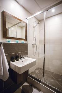 a bathroom with a sink and a shower at Hotel Crystal in Košice