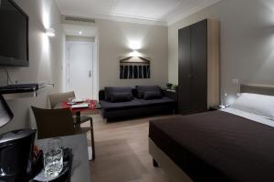 a bedroom with a bed and a living room with a couch at Regola Suite in Rome