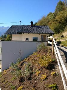 a white house on top of a hill at Appartement Schmidl in Flattach