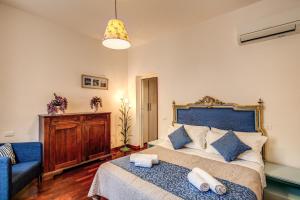 a bedroom with a large bed with a blue headboard at Boschetto in Rome