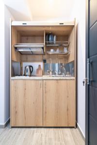a kitchen with wooden cabinets and a sink at Oasis in Sarti