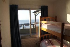 a bedroom with two bunk beds and a view of the ocean at Suite Duplex special Amarras Reales in Piriápolis