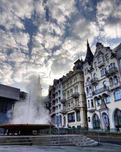 a large white building with smoke coming out of it at Ferdinandhof Apart-Hotel in Karlovy Vary