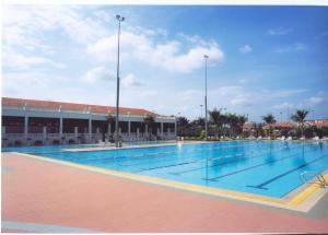 a large swimming pool in front of a building at Tanjung Puteri Golf and Resort Malaysia in Pasir Gudang