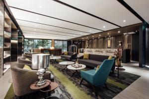 a living room with couches and chairs at Harbour 10 Hotel in Kaohsiung