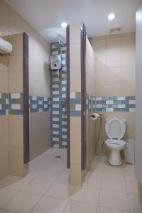 a bathroom with a toilet and a shower stall at Maayo Argao in Argao