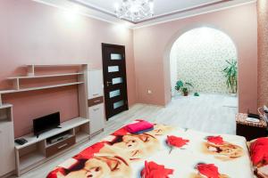 a bedroom with a large bed with red pillows at Sweet Home Apartment in Kyiv