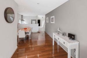 a kitchen and dining room with a table and a mirror at Beach 2 in Paynesville