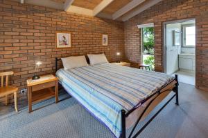 a bedroom with a large bed in a brick wall at Getaway in Paynesville