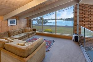 a living room with a couch and a large window at Getaway in Paynesville