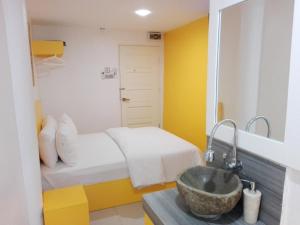 a bathroom with a sink and a bed at The Serai Cottage Boutique Hotel in Kuala Berang