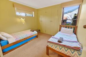 a bedroom with two beds and a window at Above Sunset in Paynesville