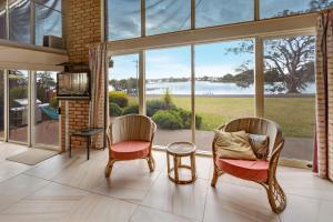 a living room with two chairs and a large window at Getaway in Paynesville
