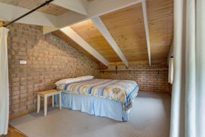 a bedroom with a bed in a brick wall at Getaway in Paynesville