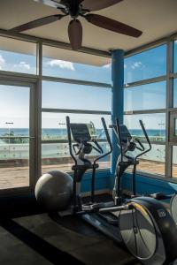 a gym with two exercise bikes in front of a window at Paradise Beach Hotel in West Bay