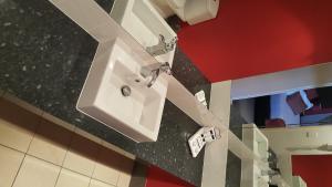 a bathroom with a sink and a mirror at Leichhardt Hotel in Rockhampton