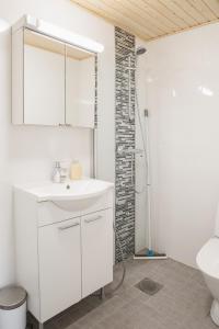 a bathroom with a white sink and a shower at First aparthotel Blitzen in Rovaniemi