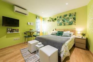 a bedroom with green walls and a bed and a desk at Ático en Céntrico edificio cerca de la Gran Vía - Madrid in Madrid