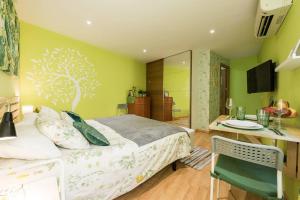 a bedroom with a bed and a desk and a table and chair at Ático en Céntrico edificio cerca de la Gran Vía - Madrid in Madrid