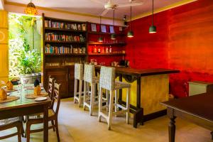 a room with a bar with chairs and a table at Thambapanni Retreat in Unawatuna