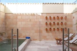 a bathroom with a swimming pool and a tub at Angels Boutique - Turismo de interior in El Port de la Selva