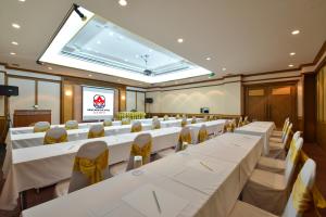 a conference room with white tables and chairs and a projection screen at Krabi Heritage Hotel in Ao Nang Beach +37 photos