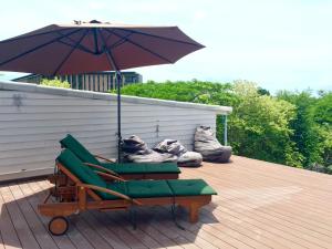 a chair and an umbrella on a deck at New Apartment Nearby Beach in Hua Hin