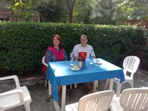 Ein Mann und eine Frau sitzen an einem blauen Tisch in der Unterkunft Hotel Traditional Inn in Neu-Delhi