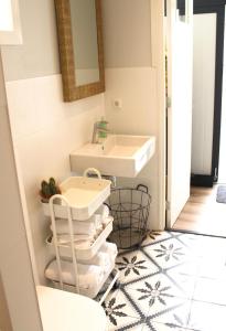 a bathroom with a sink and a toilet and towels at Appartement 4 Seasons Katwijk aan Zee in Katwijk aan Zee