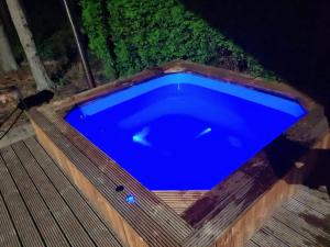 a large blue swimming pool on a wooden deck at Vacation Home Mezsargi in Pape