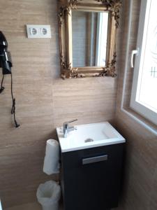 a bathroom with a sink and a mirror at H.Albar Mieres in Mieres