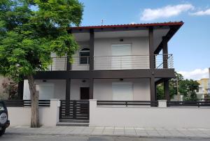 a house with a balcony on top of it at Fantastic Four Apartments in Neoi Epivates