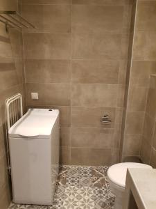 a bathroom with a toilet and a sink at Fantastic Four Apartments in Neoi Epivates +60 photos