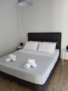 a bedroom with a bed with two towels on it at Fantastic Four Apartments in Neoi Epivates