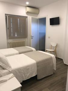 Postel nebo postele na pokoji v ubytování Hotel Cambogia + 13 fotografií