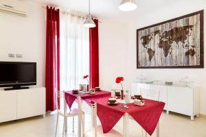 a dining room with a red table and chairs at Villa Rosina in Rho