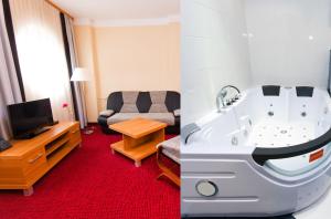 Habitación de hotel con sala de estar con bañera. en Hotel Malinowski Business, en Gliwice